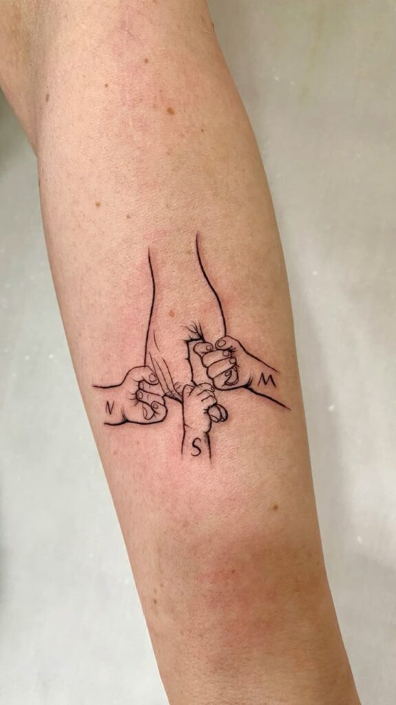 Tattoo of hands holding a finger on forearm, symbolizing family bond, simplicity in black ink.