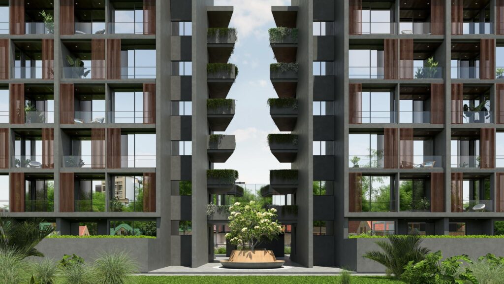 Modern apartment building facade with green balconies and courtyard tree under a clear sky.