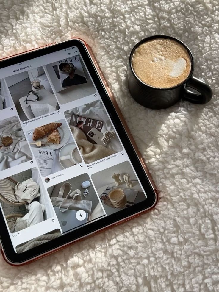 Hidden Instagram Reels Secret for Growth Tablet displaying white aesthetics on Pinterest next to a mug of frothy coffee on a textured blanket. | Sky Rye Design Tablet displaying white aesthetics on Pinterest next to a mug of frothy coffee on a textured blanket.