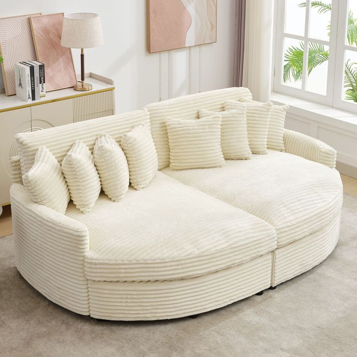 Cream-colored corduroy sofa with matching pillows in a bright, modern living room.