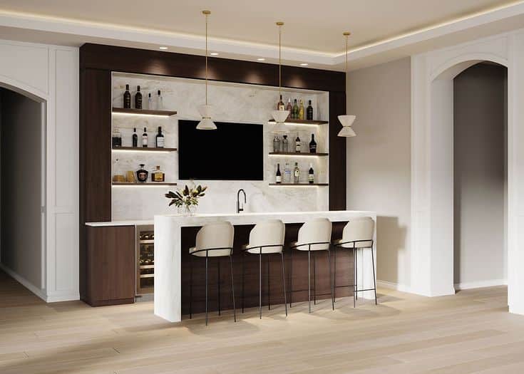 Modern home bar with marble countertop, pendant lights, and shelves stocked with liquor bottles in a stylish setting.