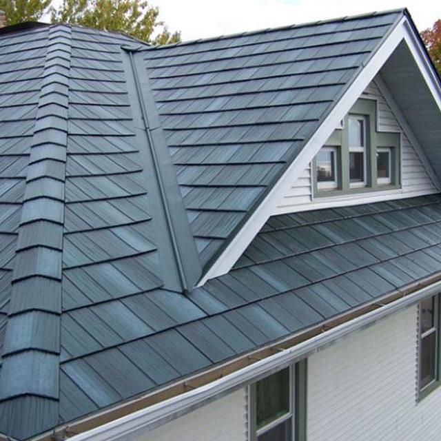 Modern house with dark blue shingle roof, highlighting clean lines and durable materials. Perfect for roofing inspiration.