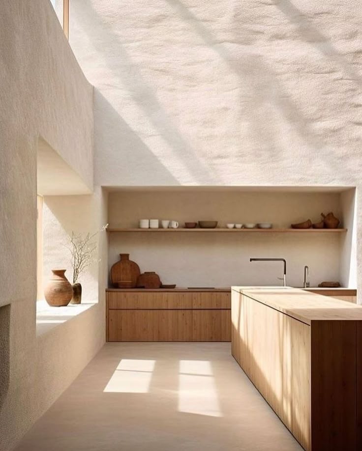 Minimalist kitchen design with wooden cabinetry, open shelving, and natural light.