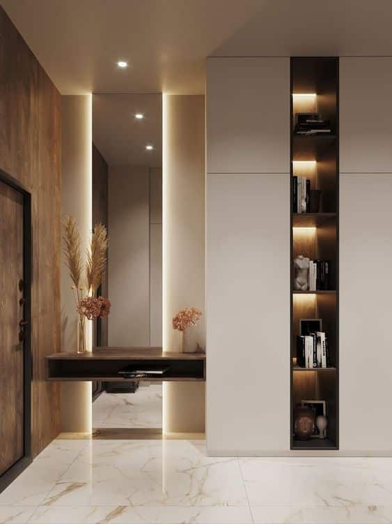 Modern hallway with wood accents, illuminated shelving, decorative vase, and marble flooring for elegant interior design.