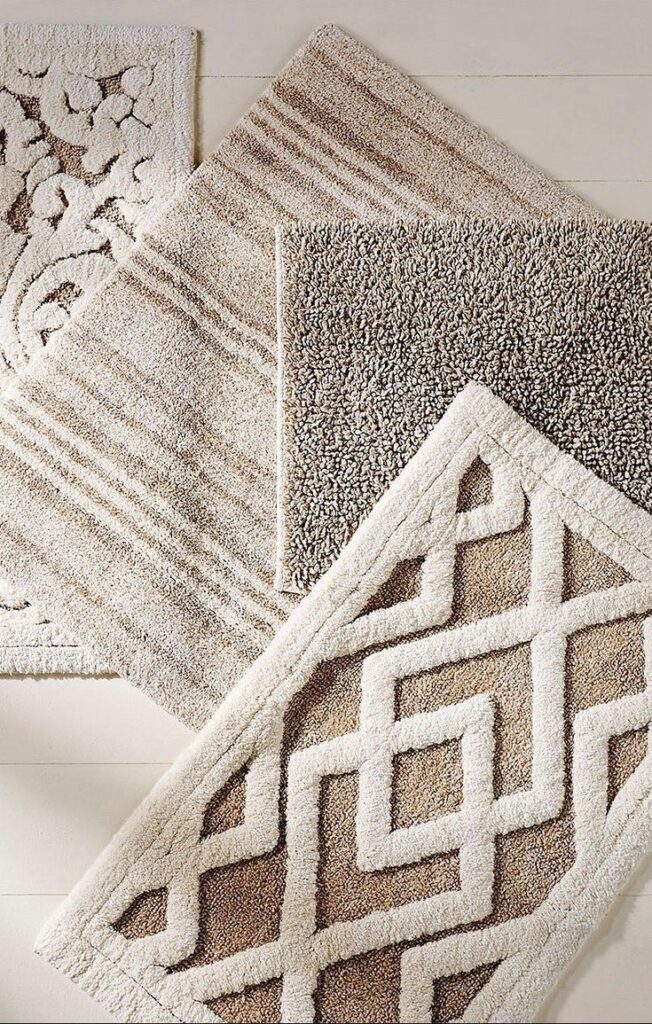 Beige and cream rugs with various textured designs, including geometric and floral patterns, on a light wood floor.