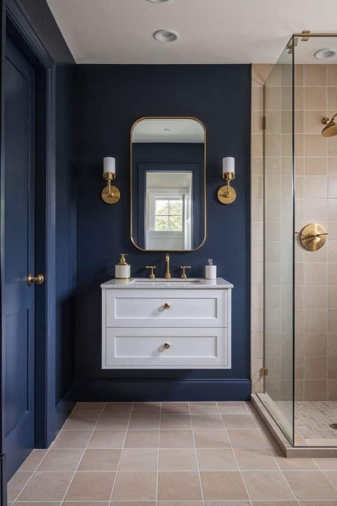 Elegant bathroom with navy walls, white vanity, gold fixtures, and glass shower. Modern and stylish design.