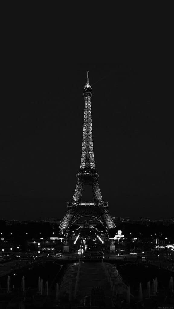 Eiffel Tower illuminated at night, Paris skyline, black and white photography.