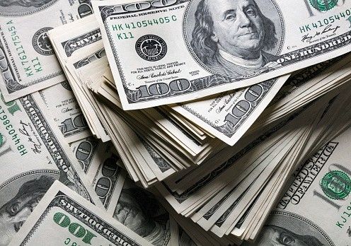 Stacked hundred-dollar bills, representing wealth, currency, finance, or cash flow.