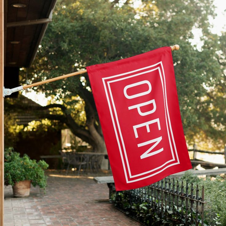 RED OPEN SIGN FLAG _ Zazzle Red Open sign hangs outside a business, surrounded by trees and outdoor seating. | Sky Rye Design Red Open sign hangs outside a business, surrounded by trees and outdoor seating.