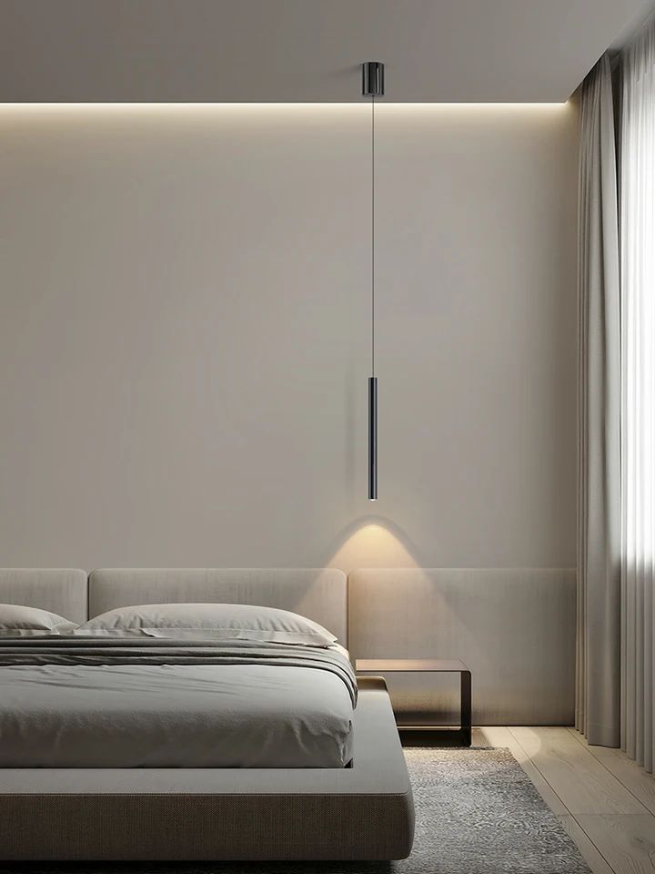 Minimalist bedroom with modern pendant light, neutral color scheme, and cozy bed.