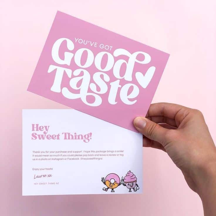 Pink card with You've Got Good Taste text, held above a Hey Sweet Thing! note against a pink background.