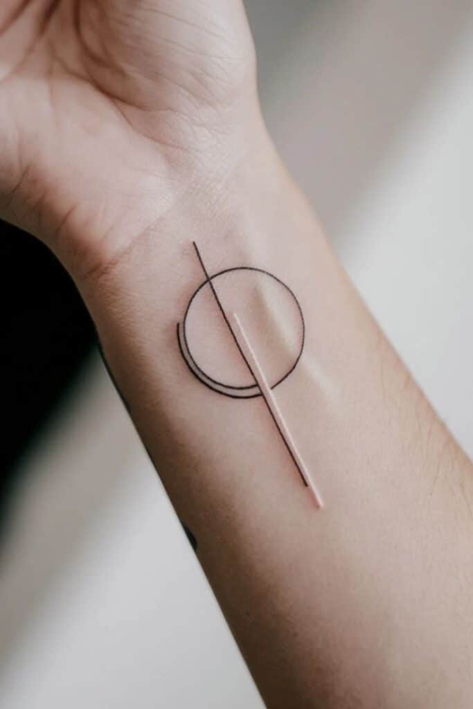 Minimalist geometric tattoo with circle and lines on forearm, modern design.