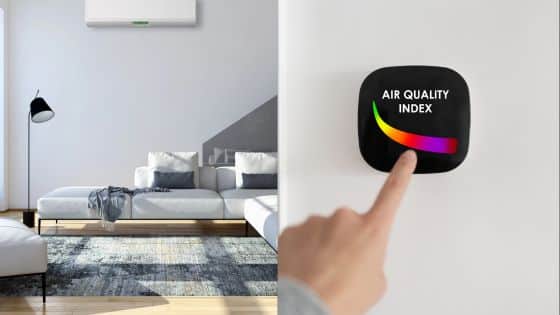 Modern living room with air conditioning unit and hand interacting with air quality index device on wall.