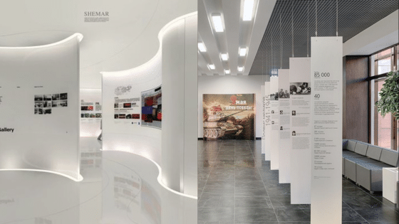 Viewing Deck Blog 23 Modern exhibition space with curved walls and informational panels, featuring a military-themed and digital display. | Sky Rye Design Modern exhibition space with curved walls and informational panels, featuring a military-themed and digital display.