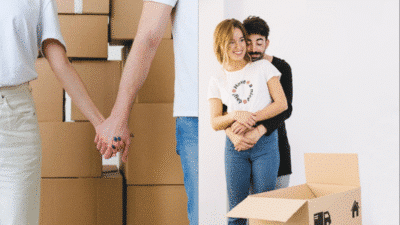 Happy couple holding hands and embracing while surrounded by moving boxes, signifying a new home and fresh start.