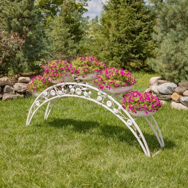 ZR230421-AW_11-600x600 White wrought iron plant stand adorned with vibrant pink flowers in a lush garden setting. | Sky Rye Design White wrought iron plant stand adorned with vibrant pink flowers in a lush garden setting.