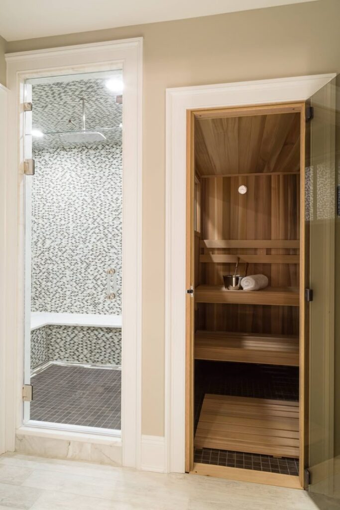 Luxurious home sauna and steam room with modern design, featuring wood interiors and mosaic tiles.