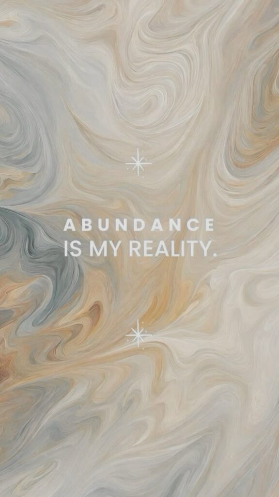 Abstract swirl background with the motivational quote Abundance is my reality in white text.