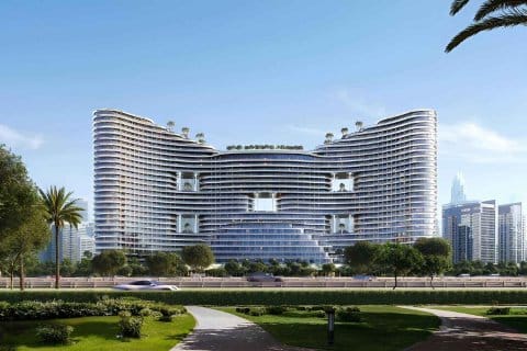 Modern architectural building with unique wave design, lush landscaping, and city skyline in the background.