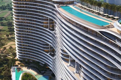 Modern hotel with wave-like architecture, featuring rooftop pools and palm trees, overlooking a golf course.