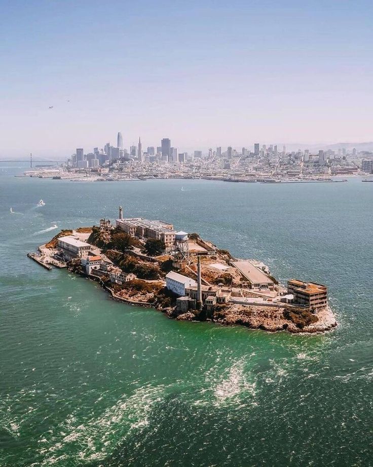 Aerial view of Alcatraz Island with San Francisco skyline in the background.