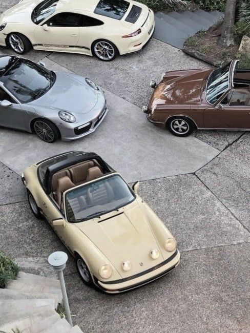 b9a06046-b1b5-4c23-aa2e-55676da8c277 Vintage and modern luxury cars parked in a stylish circular driveway. | Sky Rye Design Vintage and modern luxury cars parked in a stylish circular driveway.