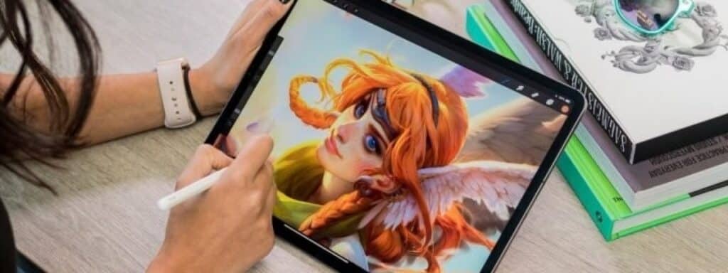 Person uses a stylus on a tablet to digitally paint a red-haired character with wings, showcasing digital art creation.