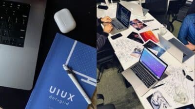 UI/UX design brainstorming session with laptops, notebooks, and digital sketches on a collaborative office table.