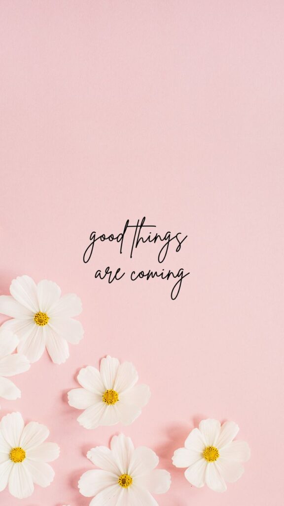 White flowers on a pink background with Good things are coming text, conveying positivity and hope.