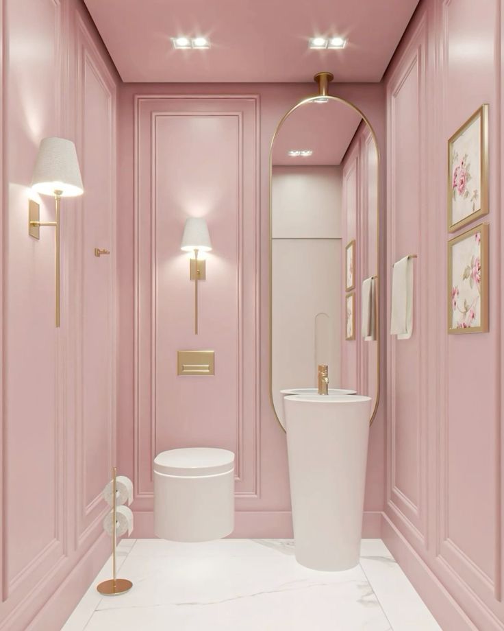 Elegant pink bathroom with modern fixtures, gold accents, and floral wall art, showcasing a sleek, minimalist design.
