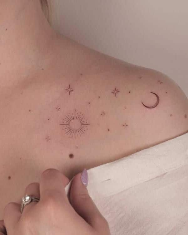 Minimalist celestial shoulder tattoo with stars, sun, and crescent moon. Elegant and delicate ink design.