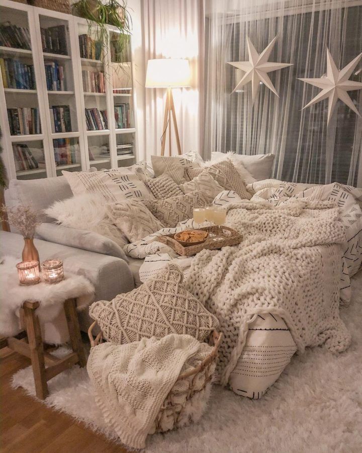 cozy hygge interior design idea with white sofa Cozy living room with fluffy pillows, blankets, warm lighting, and star decor creating a relaxing atmosphere. | Sky Rye Design Cozy living room with fluffy pillows, blankets, warm lighting, and star decor creating a relaxing atmosphere.