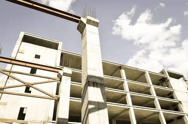 depositphotos_411863254-stock-photo-geometrical-architectural-building-shapes Concrete building under construction against a blue sky with clouds. | Sky Rye Design Concrete building under construction against a blue sky with clouds.