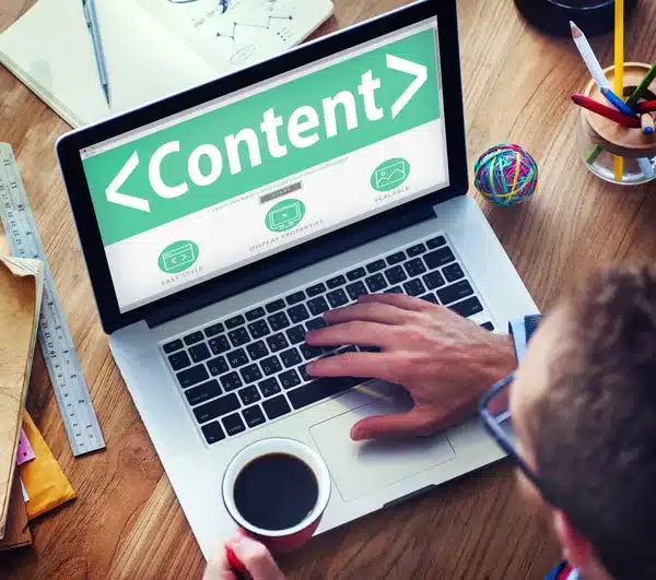 depositphotos_76999505-stock-photo-web-designer-and-office-design Person using a laptop with Content on screen, holding a coffee cup, promoting digital content creation. | Sky Rye Design Person using a laptop with Content on screen, holding a coffee cup, promoting digital content creation.