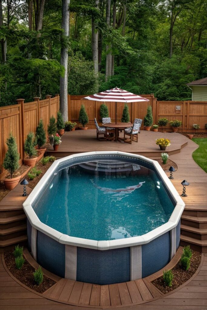 Above-ground pool with wooden decking, surrounded by a lush garden, seating area, and striped umbrella.