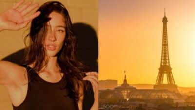 Woman posing in sunlight next to the Eiffel Tower at sunset, Paris.