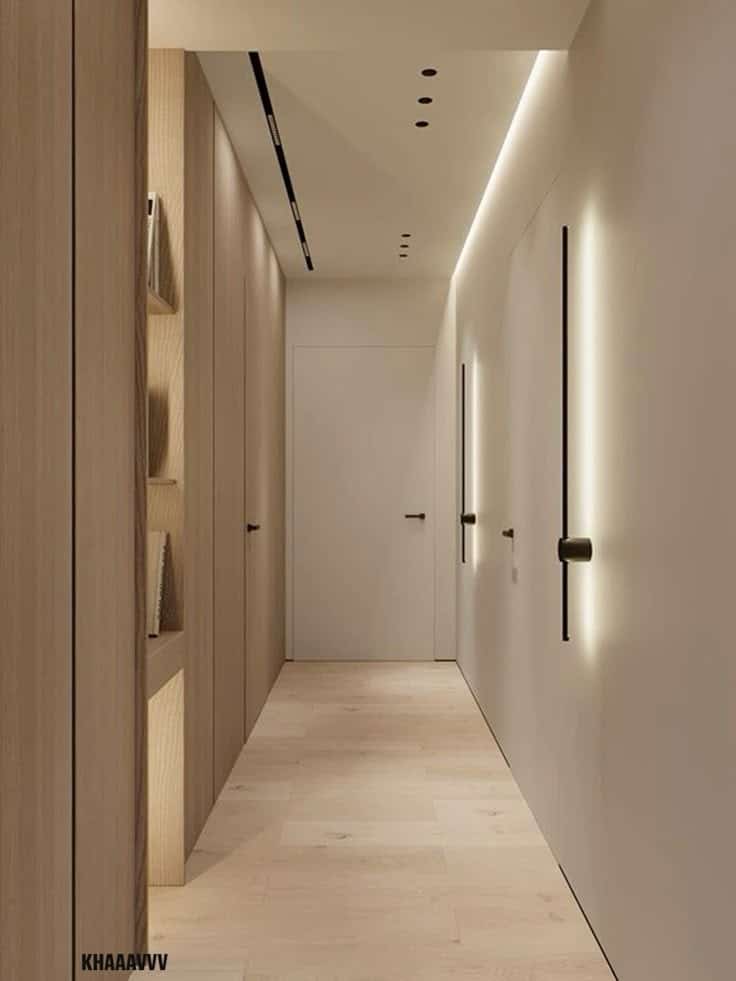 Minimalist hallway with warm lighting, wooden floors, and sleek storage shelves.