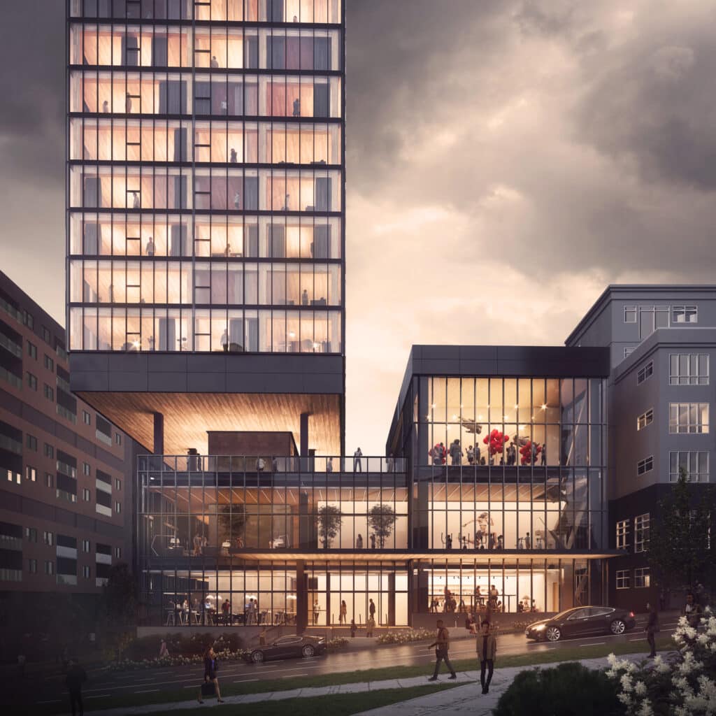 Modern office building with glass facade during sunset, featuring people visible inside and outside.