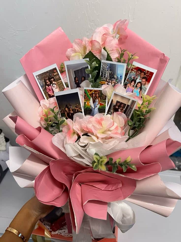 Pink and white bouquet with printed photos and green foliage, crafted with decorative paper.
