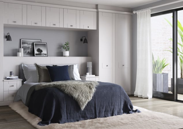 seton-white-ash-bedroom-cgi-04 Modern bedroom with navy bedding, white furniture, and large window. Minimalist decor with black wall lamps and plants. | Sky Rye Design Modern bedroom with navy bedding, white furniture, and large window. Minimalist decor with black wall lamps and plants.