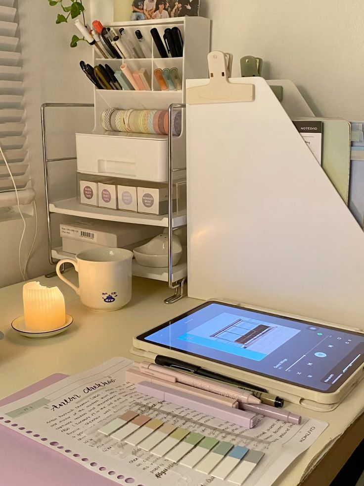 study aesthetic Cozy study desk with tablet, stationery organizer, candle, and pastel highlighters for a peaceful work environment. | Sky Rye Design Cozy study desk with tablet, stationery organizer, candle, and pastel highlighters for a peaceful work environment.