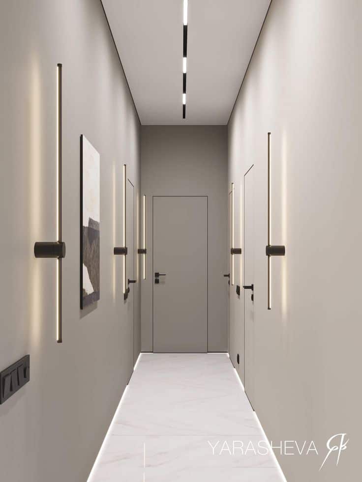 Minimalist hallway design with sleek wall and ceiling lights, modern doors, and marble floor.
