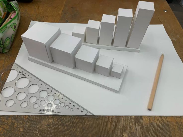 _ 1 3D paper models on white sheet with pencil and ruler, showcasing different block sizes. | Sky Rye Design 3D paper models on white sheet with pencil and ruler, showcasing different block sizes.