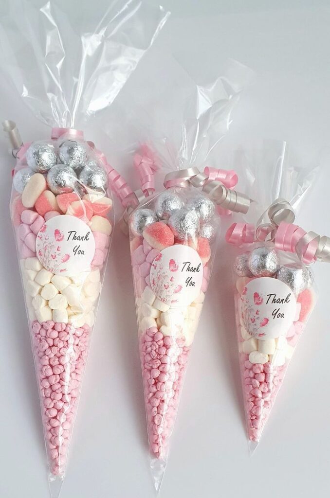 Pastel-themed candy bags with Thank You tags, featuring pink and white sweets, ideal for parties or gifts.