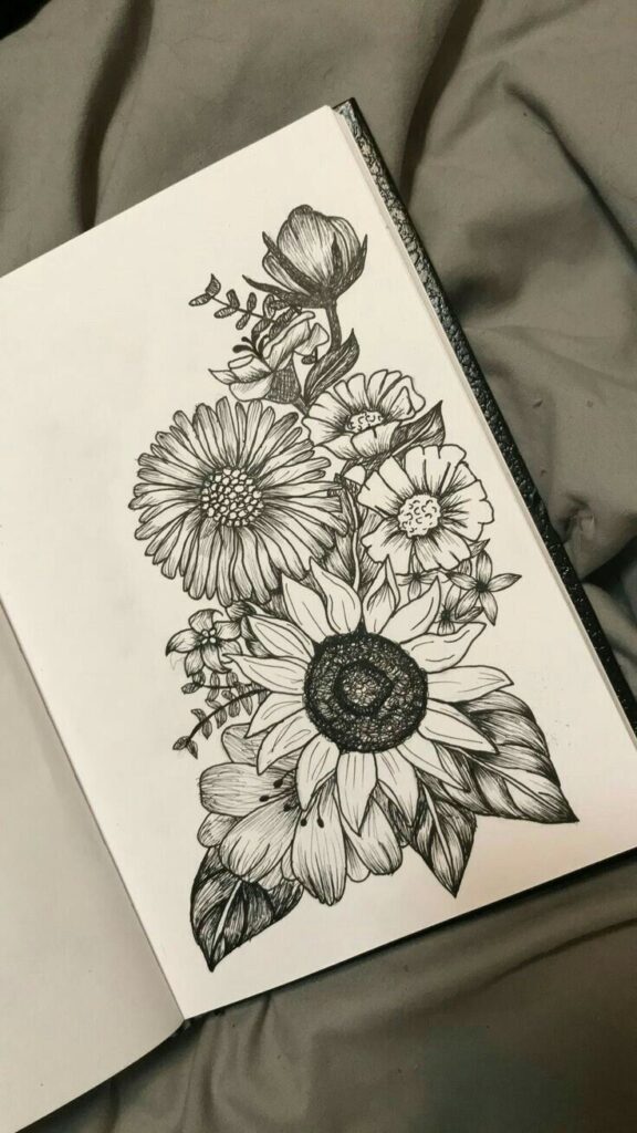 12edd2af-8d4c-45e4-a064-9f906299fa76 Sketchbook page with detailed black and white floral illustration, featuring sunflowers and various blossoms. | Sky Rye Design Sketchbook page with detailed black and white floral illustration, featuring sunflowers and various blossoms.