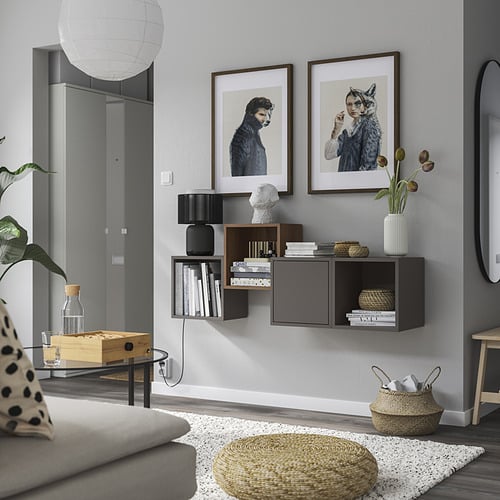 Modern living room with stylish wall art, sleek shelving, and cozy decor. Minimalist design with neutral tones.