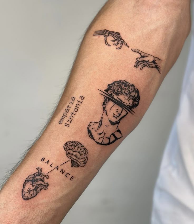 Arm tattoo featuring artistic elements: hands, a cutout head, brain, heart, and words empatia and BALANCE.