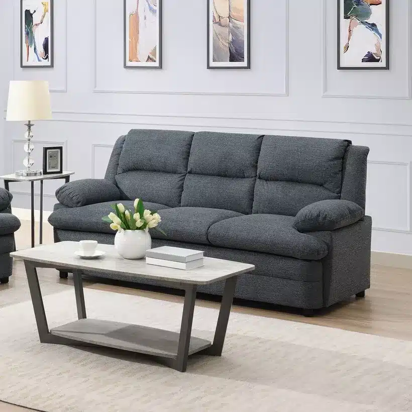 Modern living room with a cozy gray sofa, elegant coffee table, and wall art. Perfect for relaxing and entertaining.