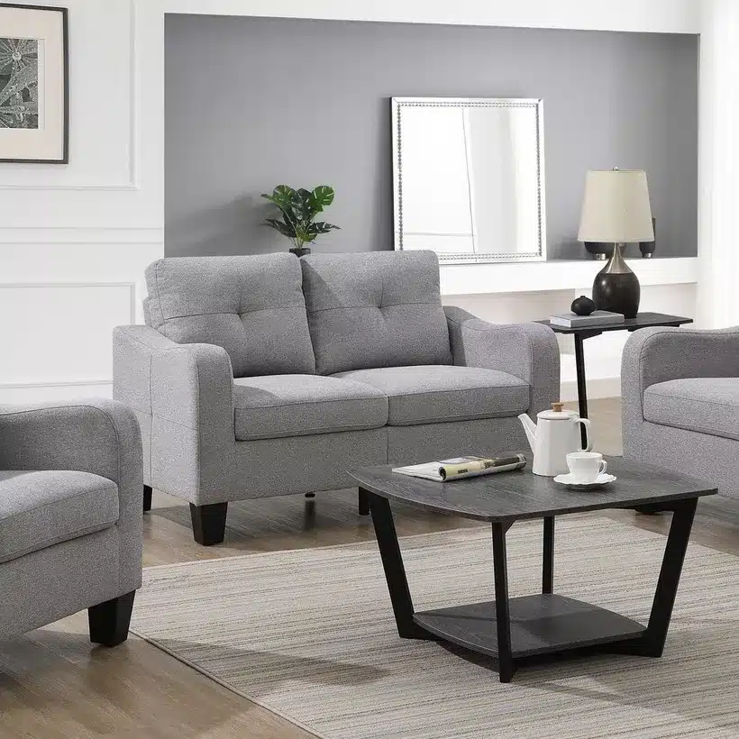 Modern living room with gray sofas, coffee table, lamp, and wall art for stylish home decor.