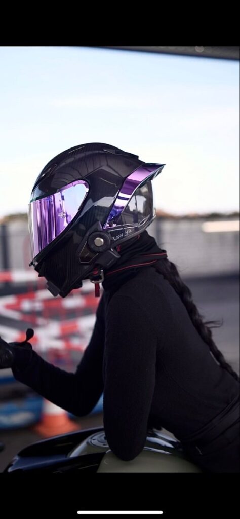 1724a9c587e37801242b586ce04c7924 Person in black riding gear wearing a futuristic helmet with reflective visor, on a motorcycle at a track. | Sky Rye Design Person in black riding gear wearing a futuristic helmet with reflective visor, on a motorcycle at a track.